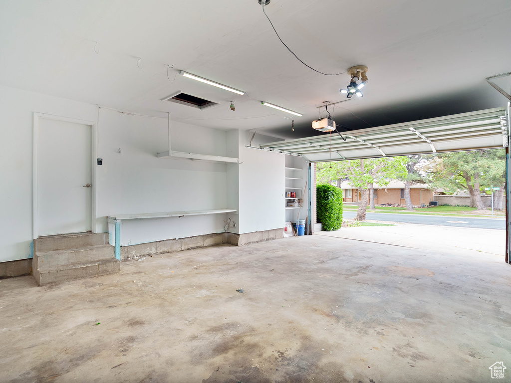 Garage featuring a garage door opener