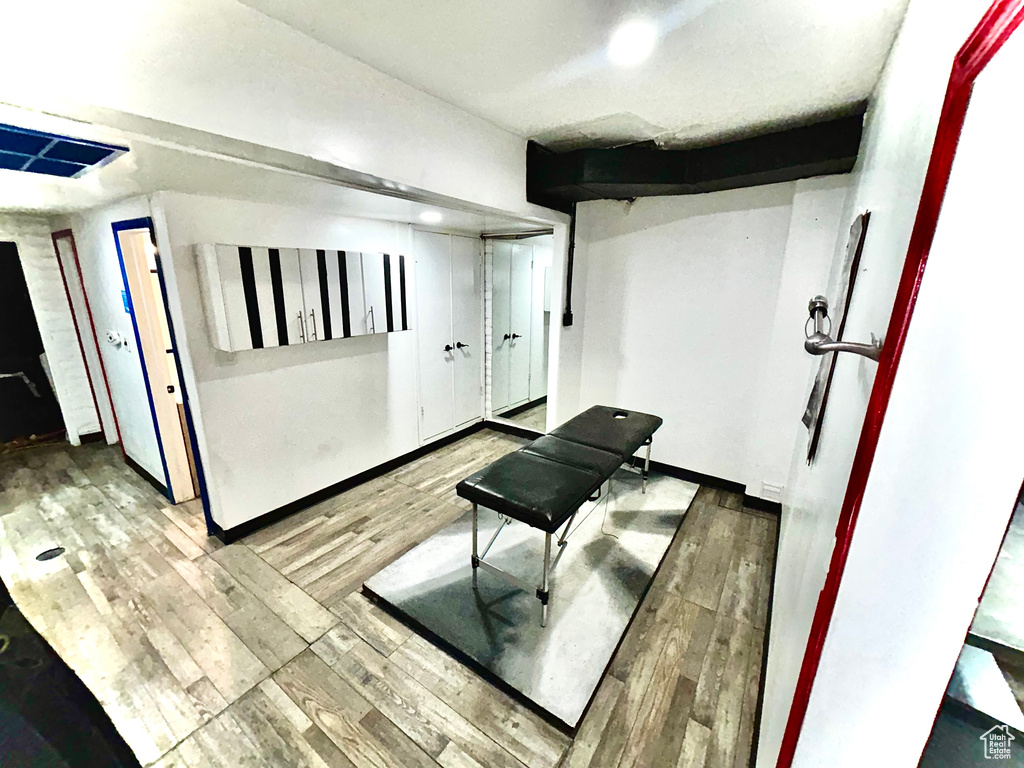 Workout area with wood finished floors