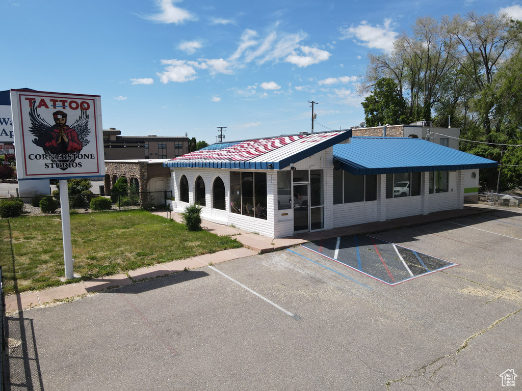 View of building exterior with uncovered parking