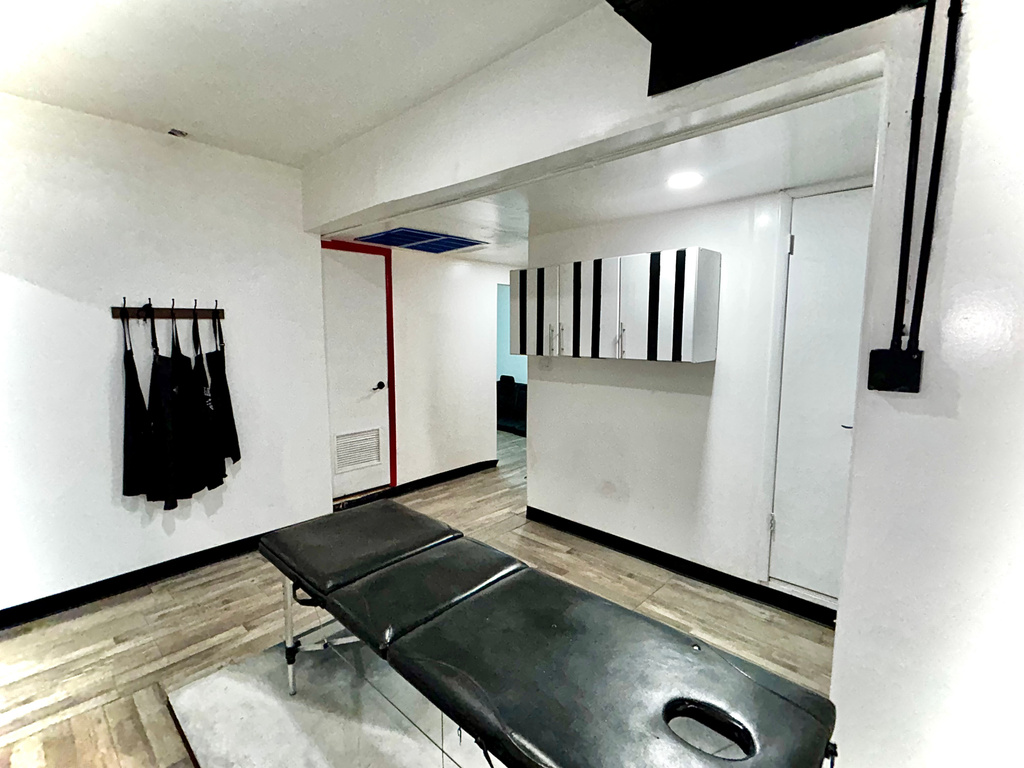 Workout room with wood finished floors and baseboards