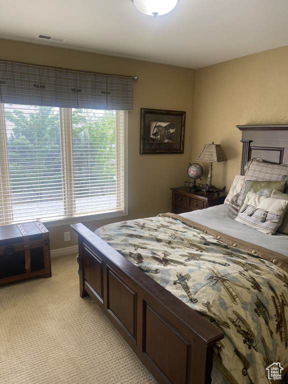 Bedroom with light colored carpet