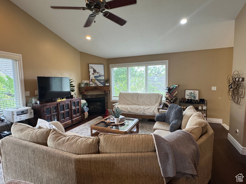 Living area with vaulted ceiling, dark wood finished floors, baseboards, a ceiling fan, and recessed lighting