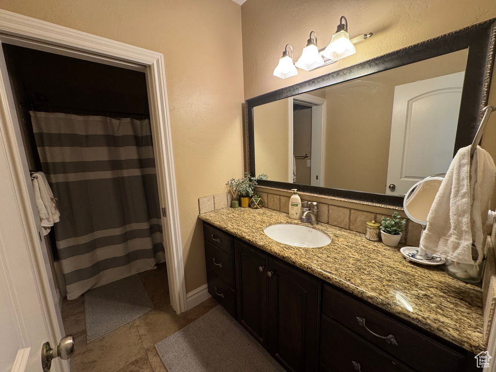 Full bathroom featuring vanity and a shower with curtain