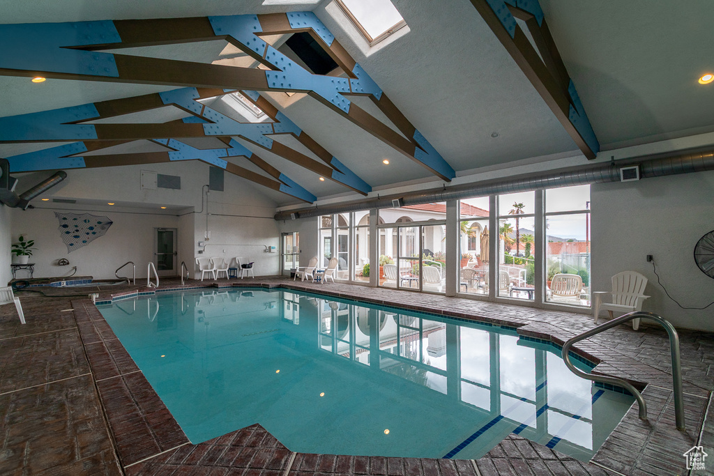 Indoor pool featuring a skylight
