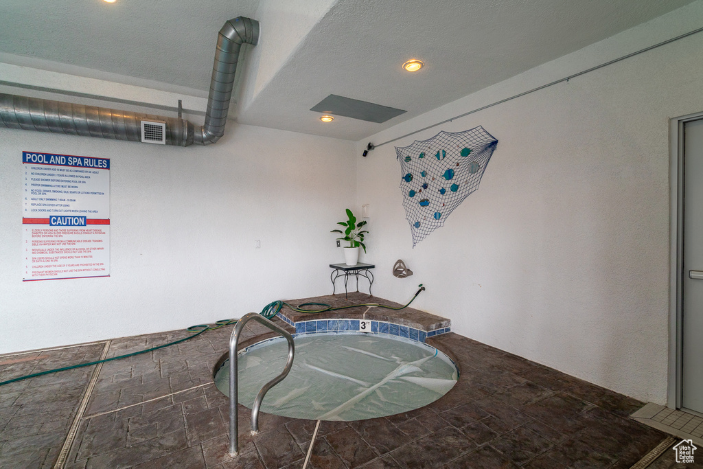 Misc room featuring stone finish flooring and recessed lighting