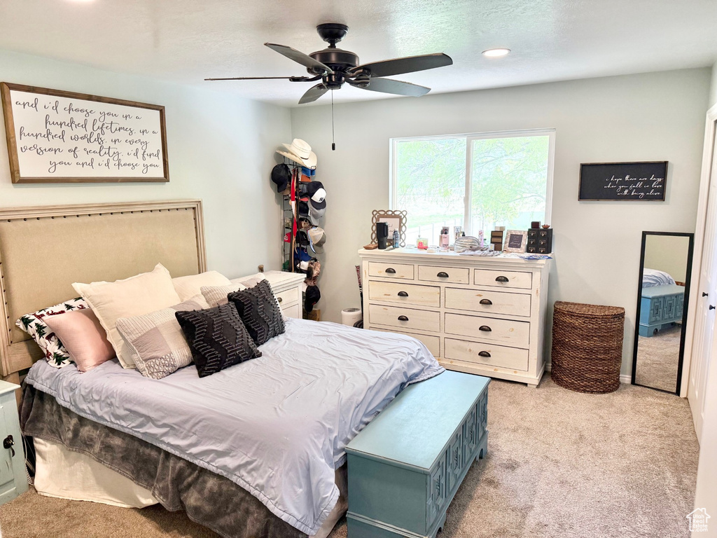 Bedroom featuring light colored carpet, ceiling fan, and recessed lighting