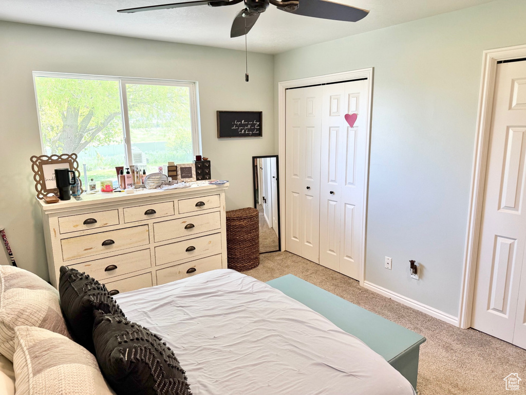 Bedroom featuring light carpet and a ceiling fan