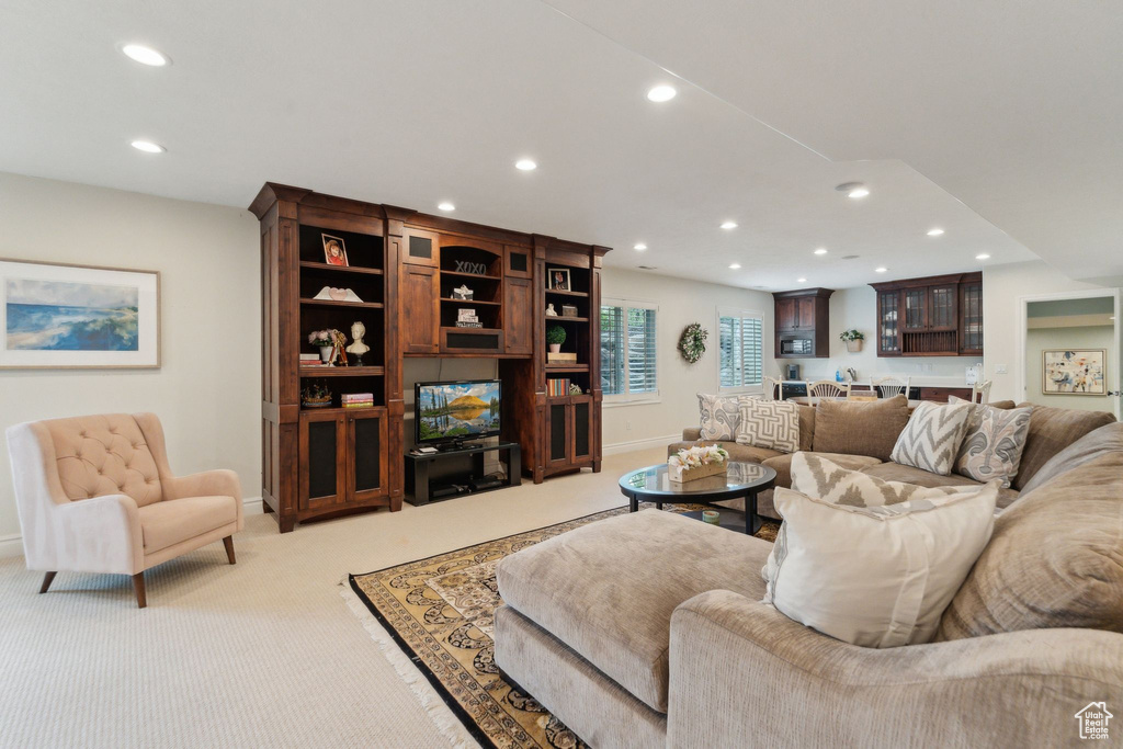 Living room featuring light colored carpet, recessed lighting, and baseboards