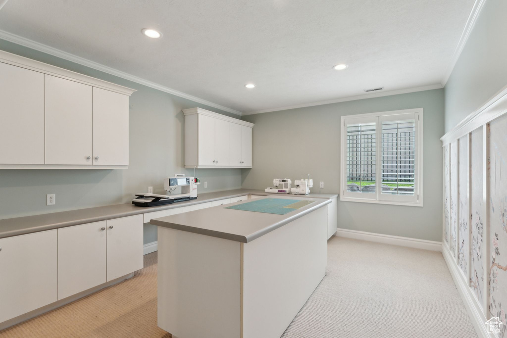 Kitchen featuring recessed lighting, crown molding, light countertops, baseboards, and light carpet