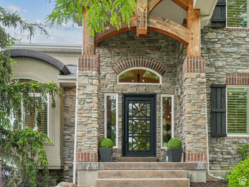 Entrance to property with stone siding