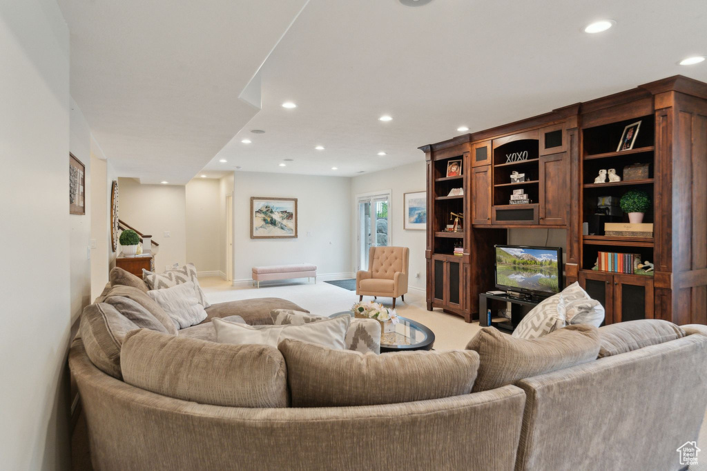 Carpeted living room with recessed lighting and baseboards
