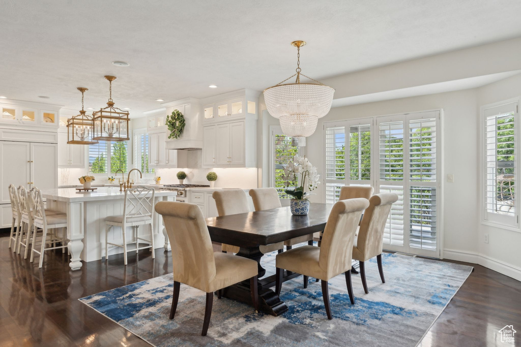 Dining room featuring a chandelier, dark wood-style floors, recessed lighting, and baseboards
