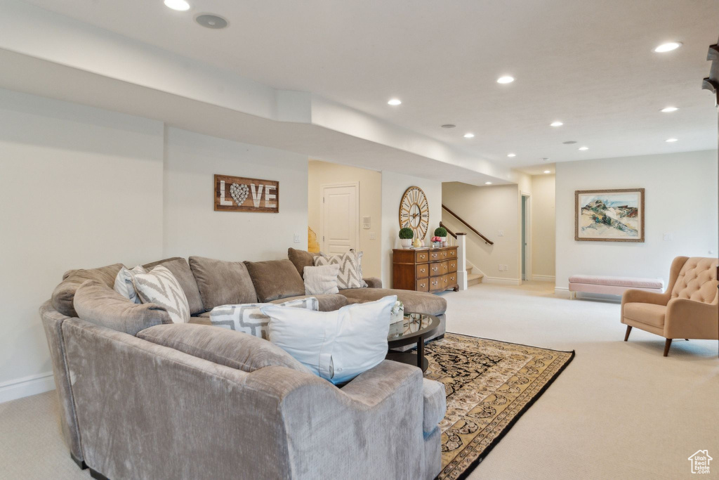 Living area with light colored carpet, stairs, recessed lighting, and baseboards