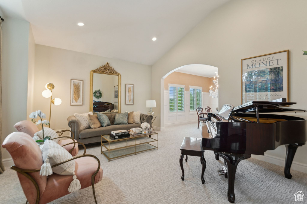 Living area featuring arched walkways, carpet flooring, a chandelier, recessed lighting, and baseboards