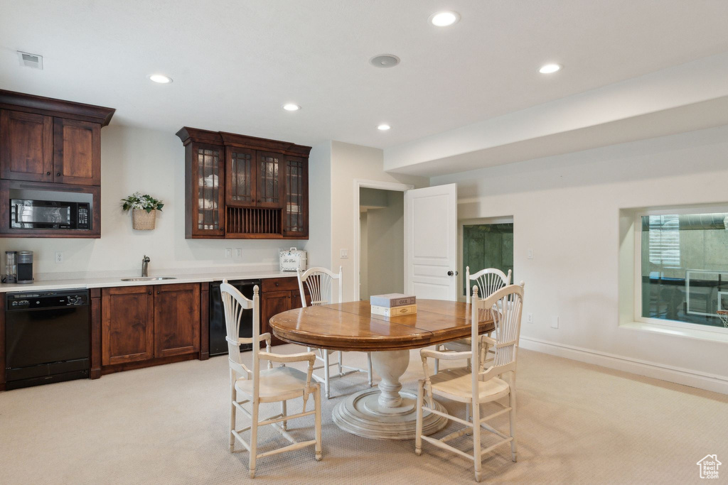 Dining space with recessed lighting, light colored carpet, and baseboards