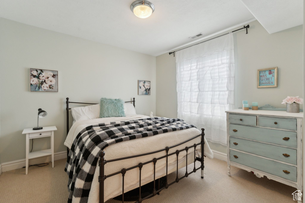 Bedroom featuring light colored carpet and baseboards