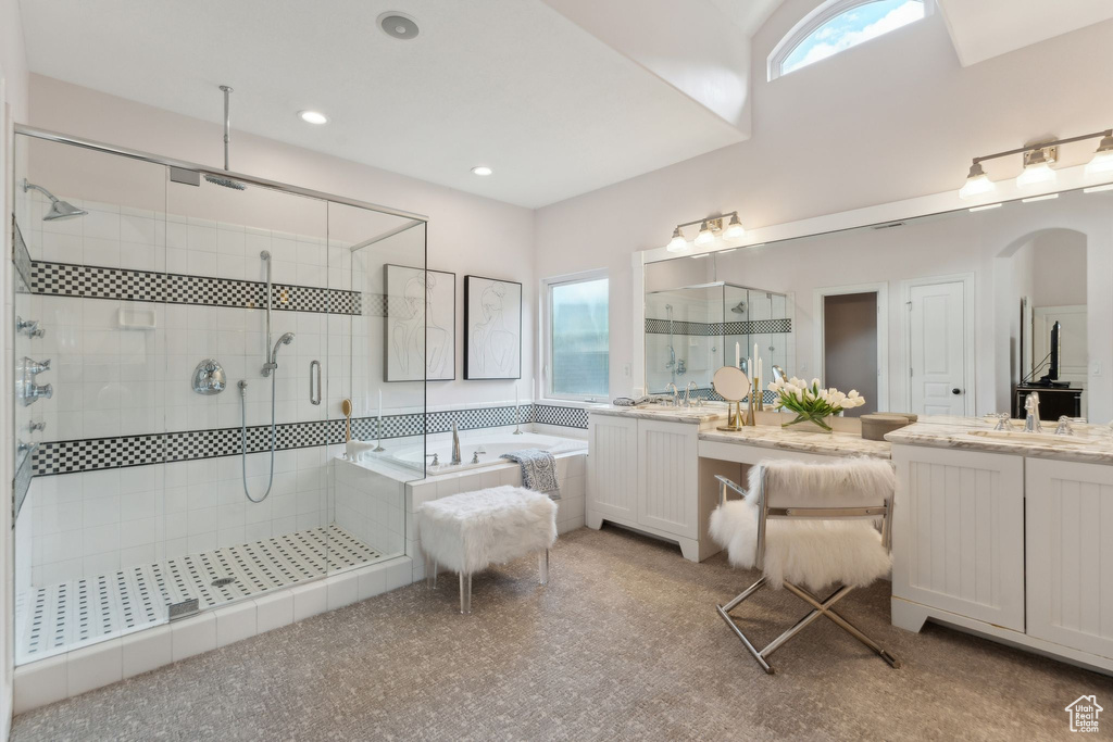 Bathroom featuring a shower stall, a bath, vanity, and recessed lighting