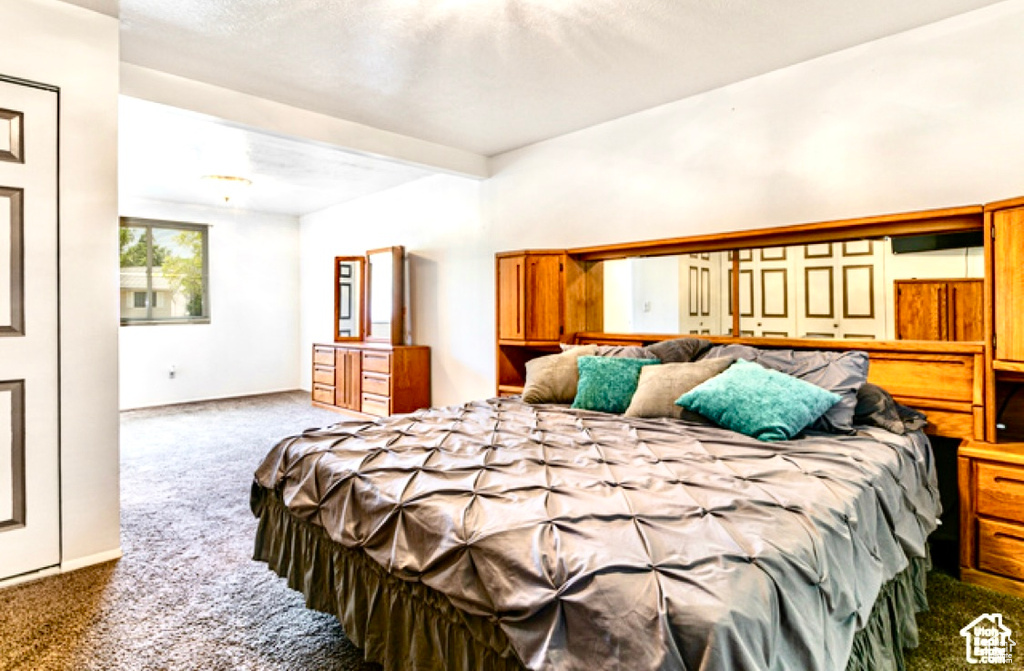 Bedroom featuring carpet floors and baseboards