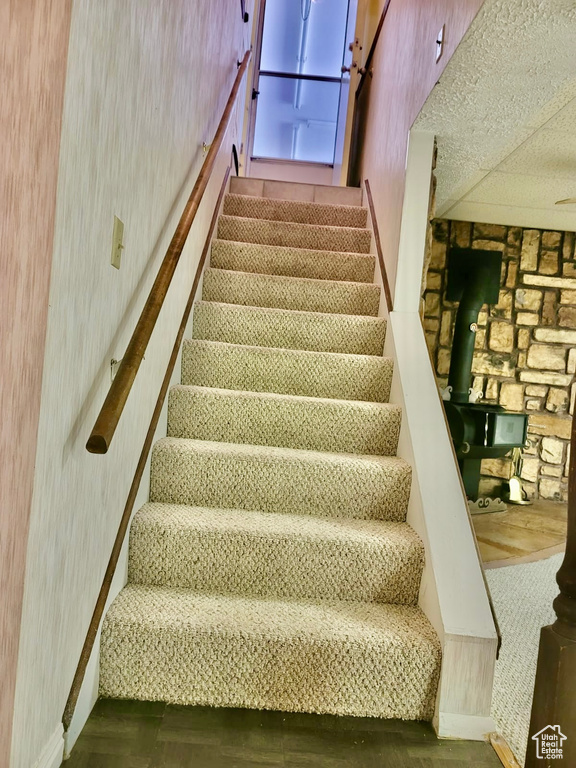 Stairs with baseboards and wood finished floors