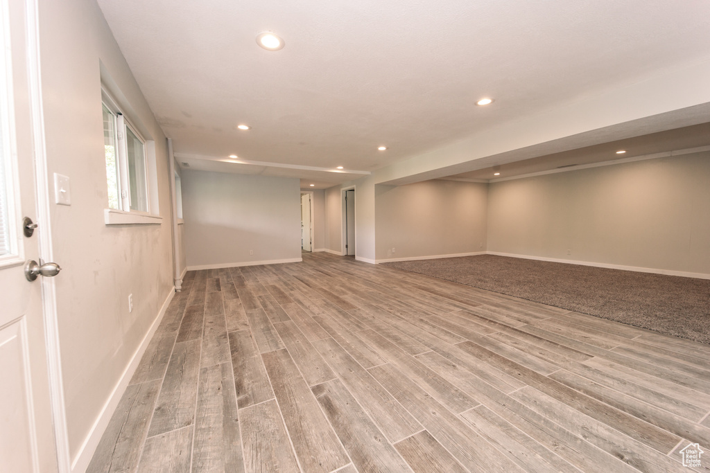 Below grade area with recessed lighting, light wood-style flooring, and baseboards