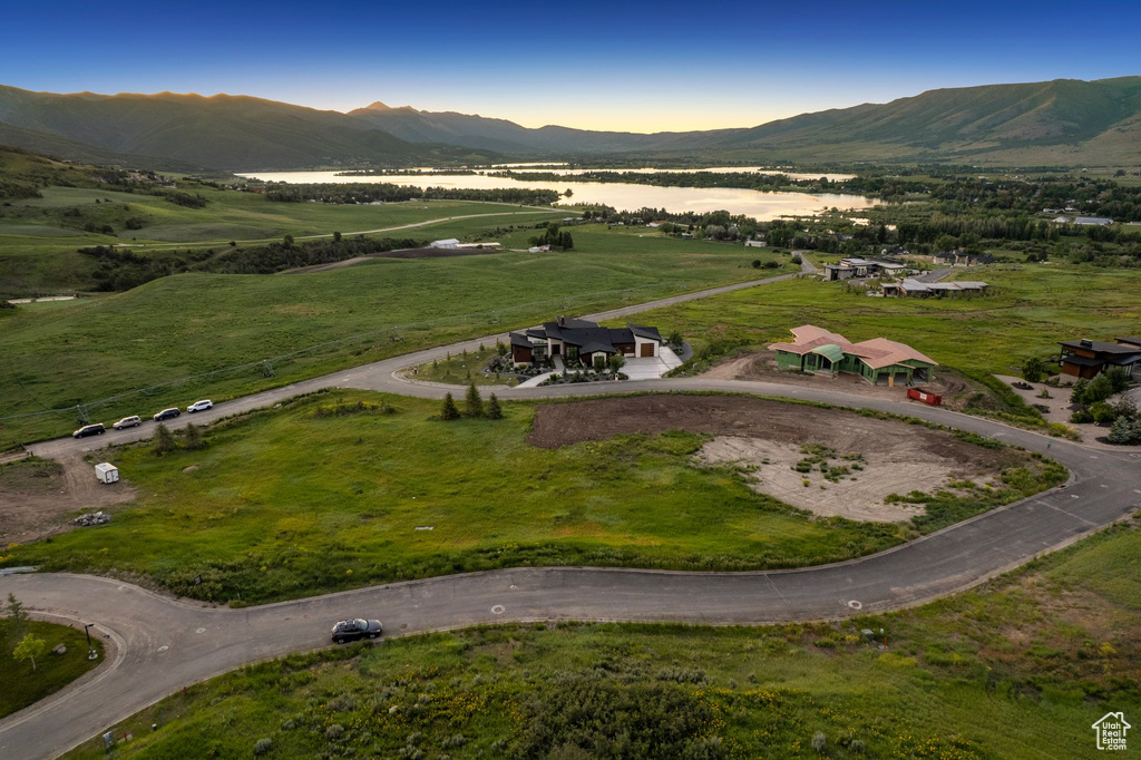 Aerial overview of property's location featuring a mountain backdrop and rural landscape