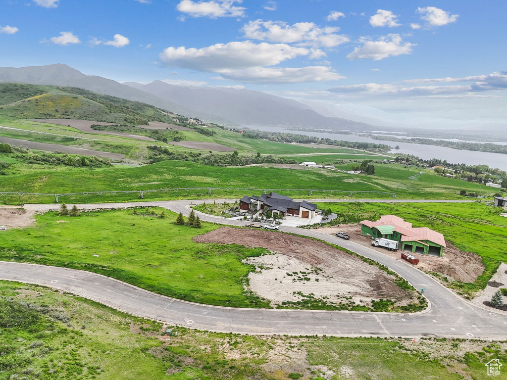 View of subject property featuring a water and mountain view