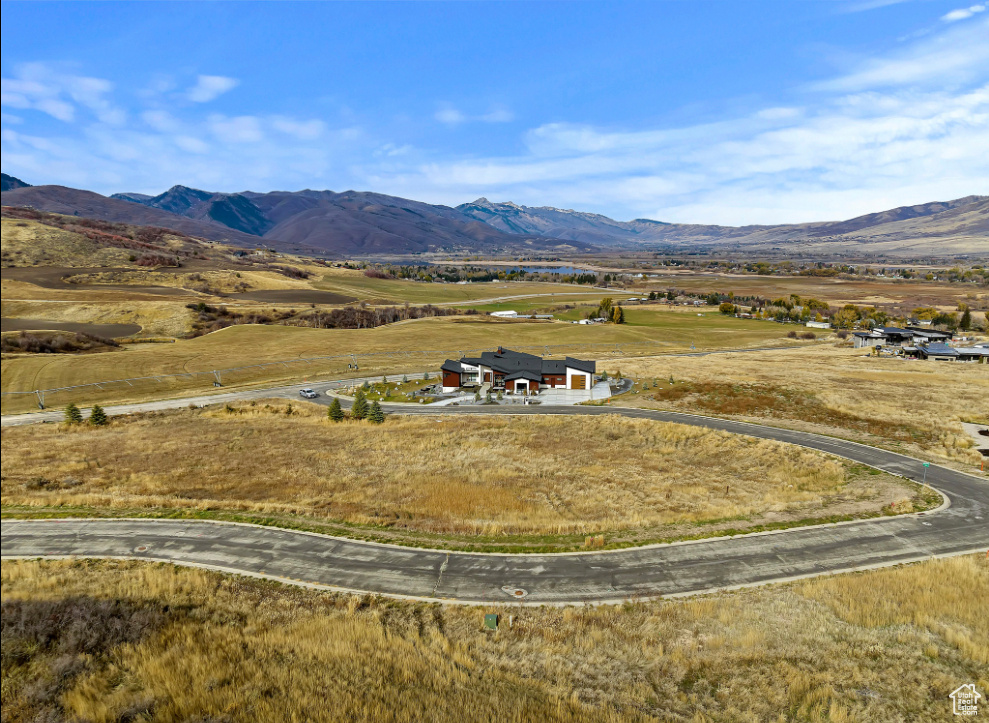 View of subject property featuring a mountainous background
