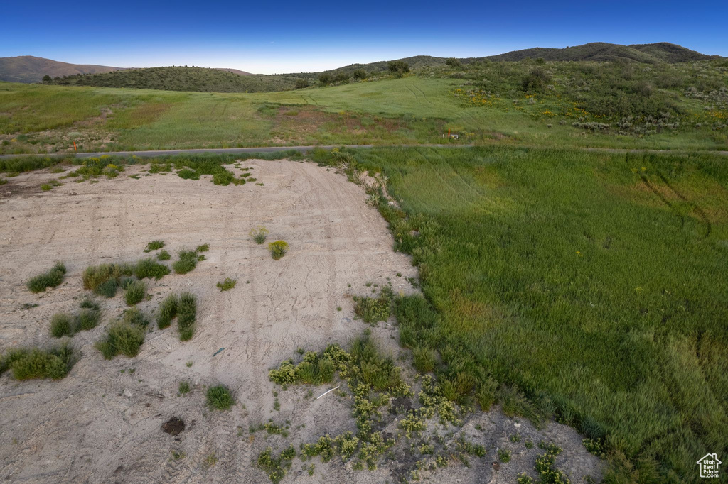 Aerial overview of property's location with a mountainous background and rural landscape