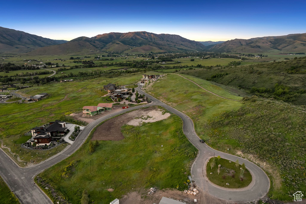 Aerial overview of property's location with a mountain backdrop and rural landscape