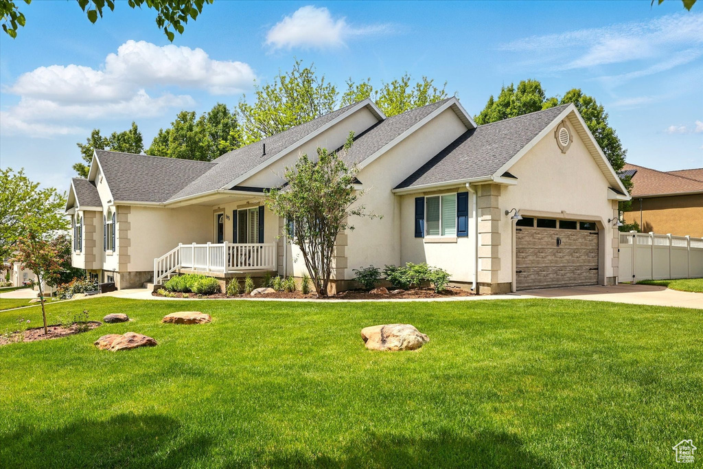 Ranch-style home with an attached garage, concrete driveway, roof with shingles, stucco siding, and a porch
