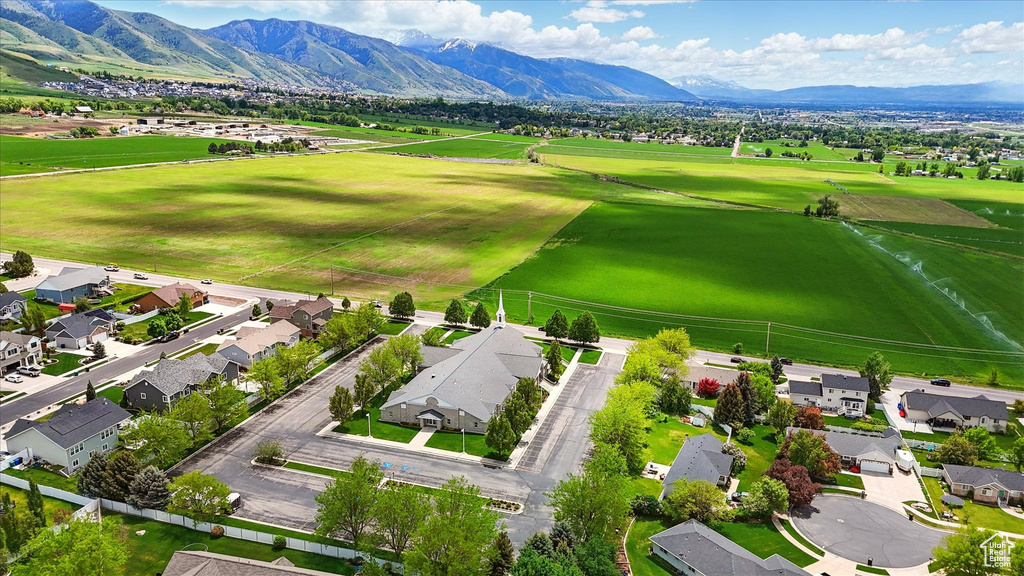 Aerial view of residential area featuring a mountainous background and a local golf course