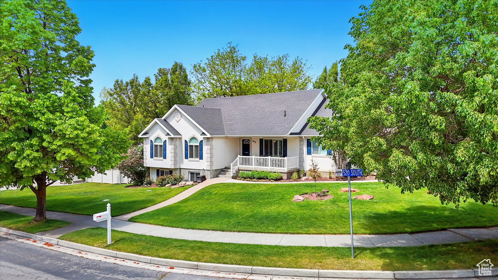 Single story home featuring a porch and a front yard