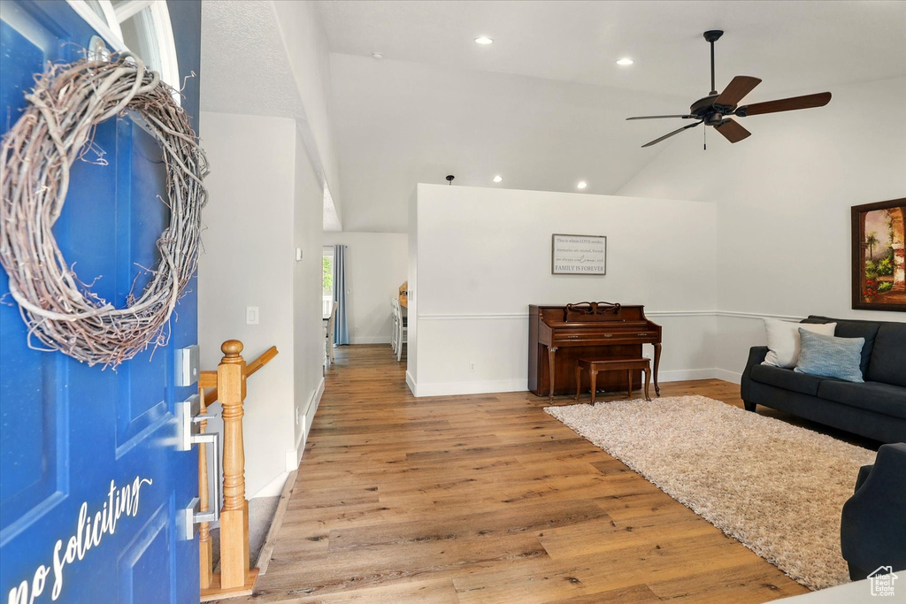 Entryway with high vaulted ceiling, a ceiling fan, baseboards, recessed lighting, and wood finished floors