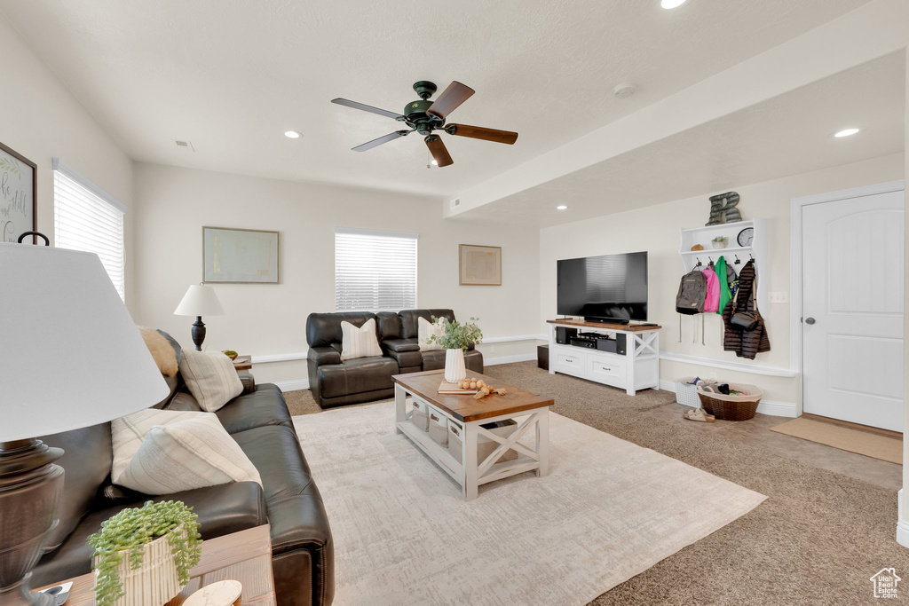 Carpeted living room with a ceiling fan, recessed lighting, and baseboards