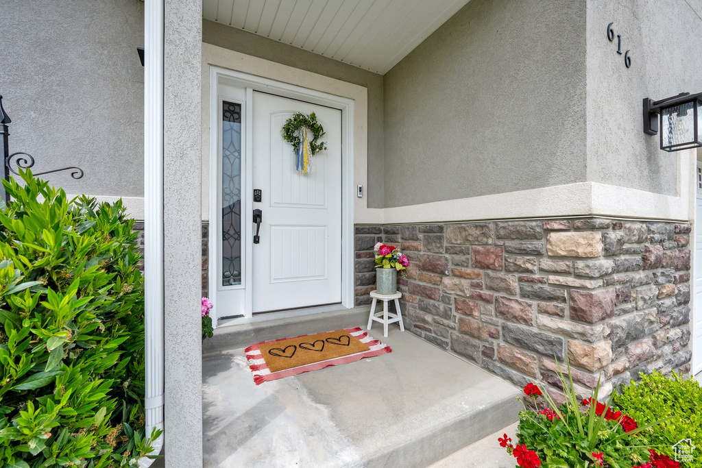 Doorway to property with stucco siding