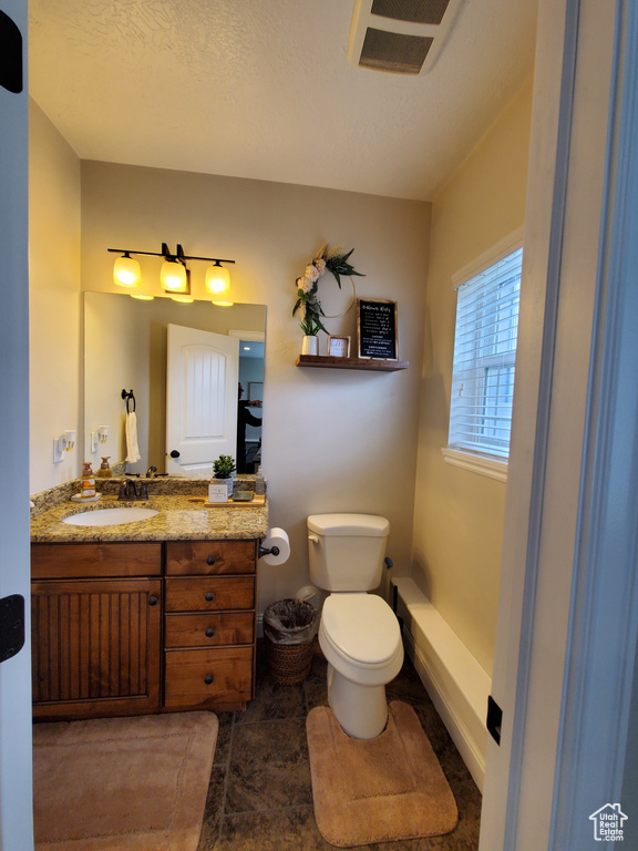 Half bath featuring toilet and vanity