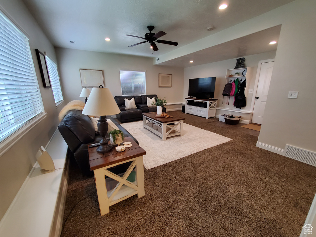 Living room featuring a ceiling fan, dark colored carpet, recessed lighting, and baseboards