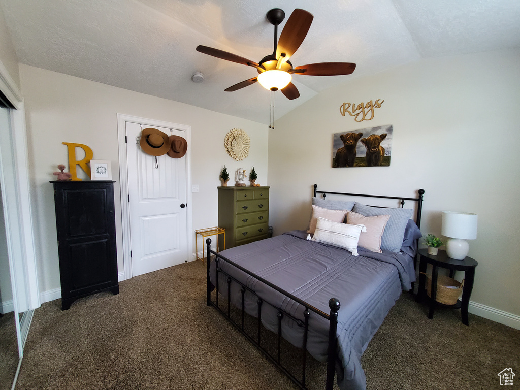 Bedroom with carpet, lofted ceiling, a ceiling fan, and baseboards