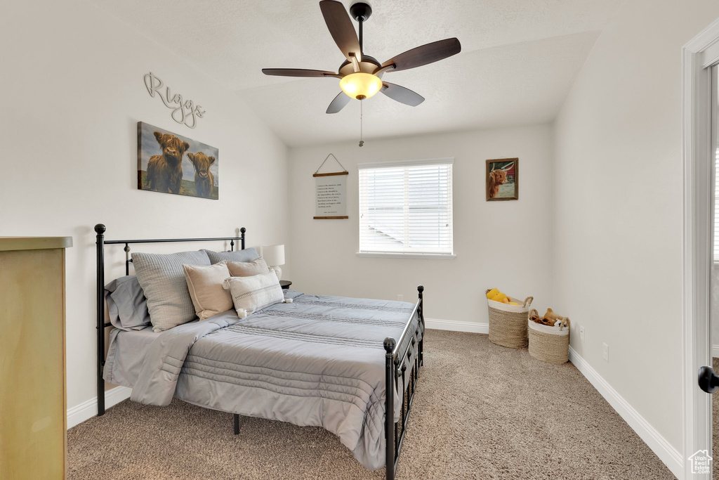 Carpeted bedroom with baseboards and ceiling fan
