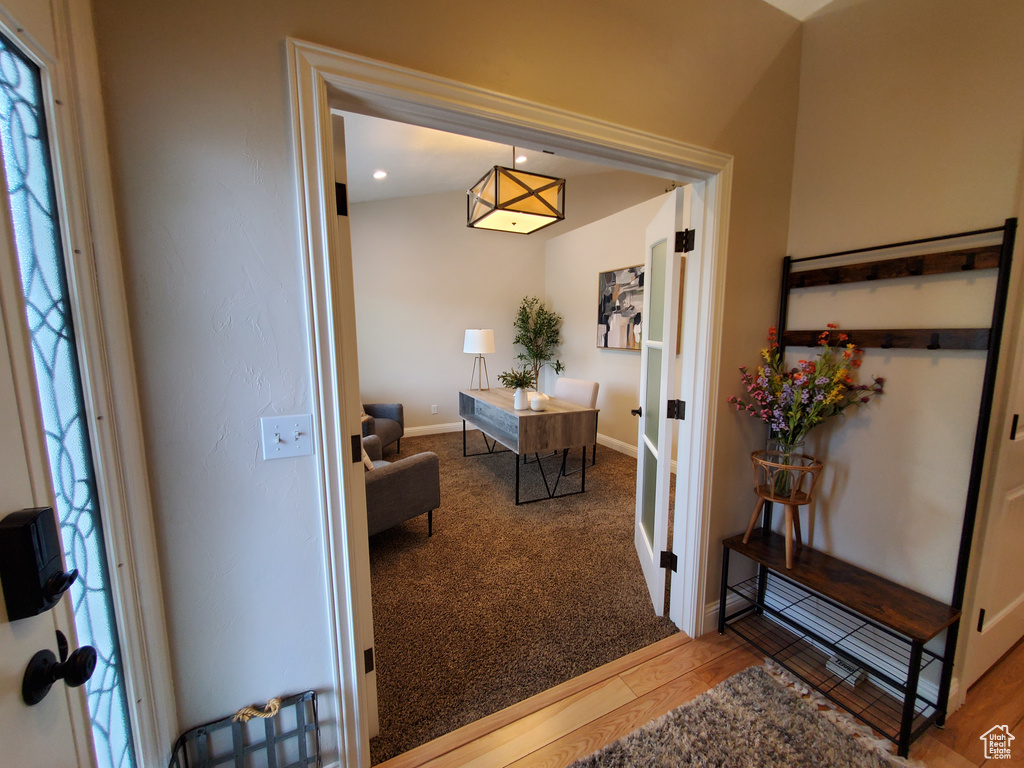 Entryway featuring wood finished floors, baseboards, and french doors