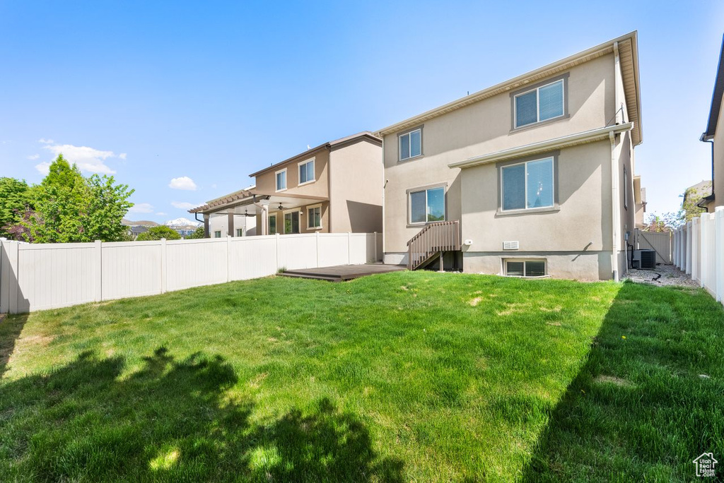 Rear view of property featuring stucco siding