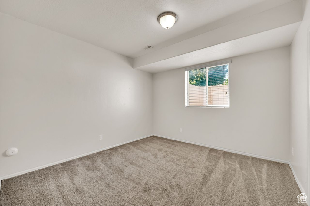 Empty room featuring carpet floors and baseboards