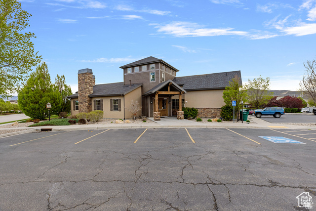 View of property with uncovered parking