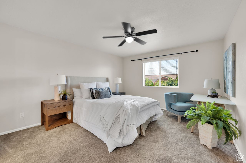 Carpeted bedroom with baseboards and ceiling fan