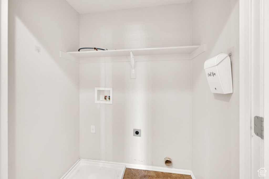 Washroom featuring hookup for a washing machine, hookup for an electric dryer, and baseboards