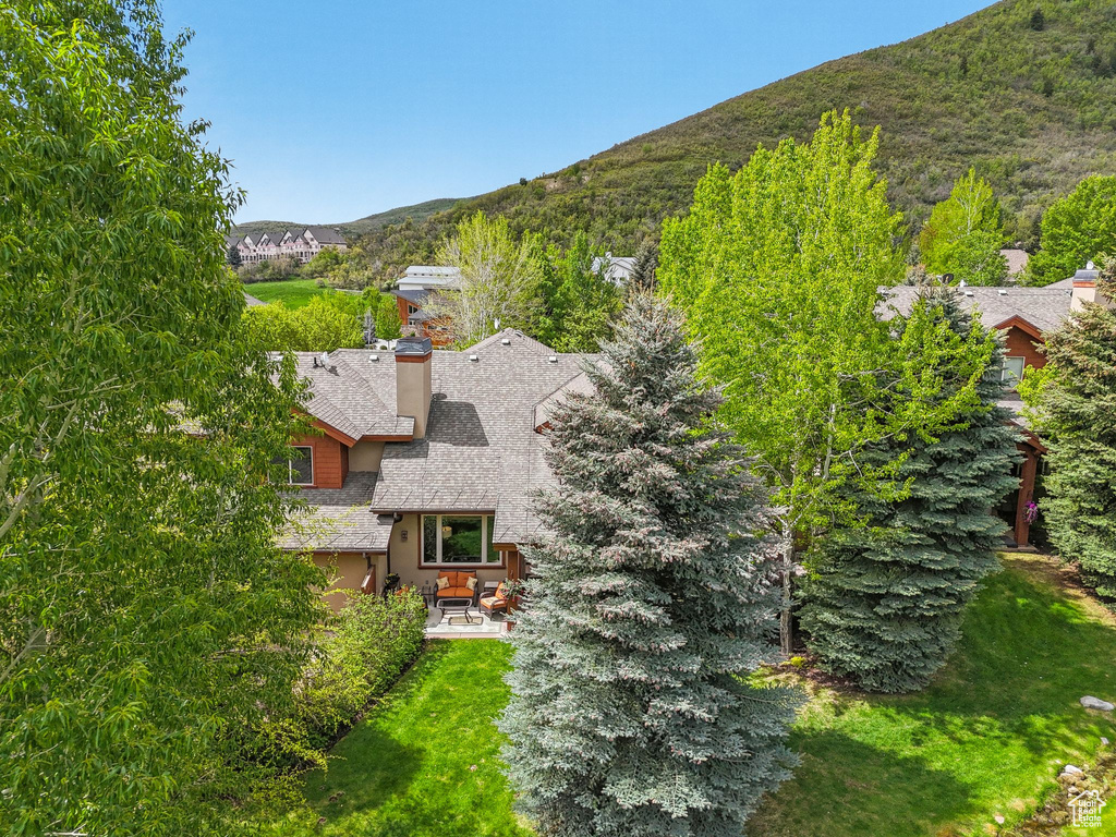 Aerial view of property and surrounding area featuring mountains