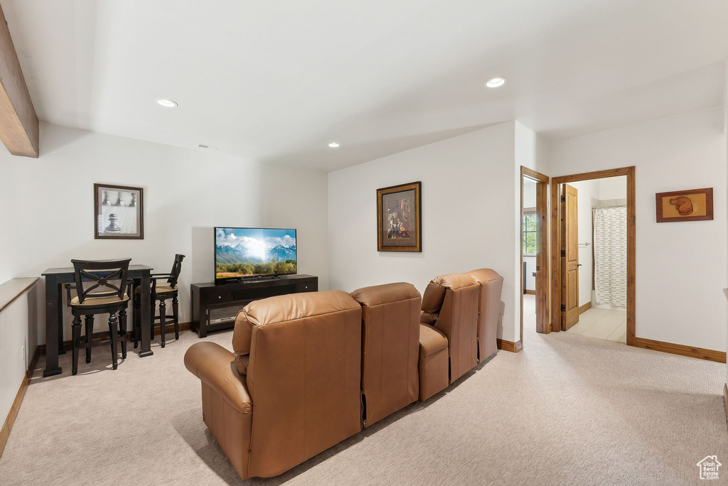 Living room featuring light colored carpet, baseboards, and recessed lighting