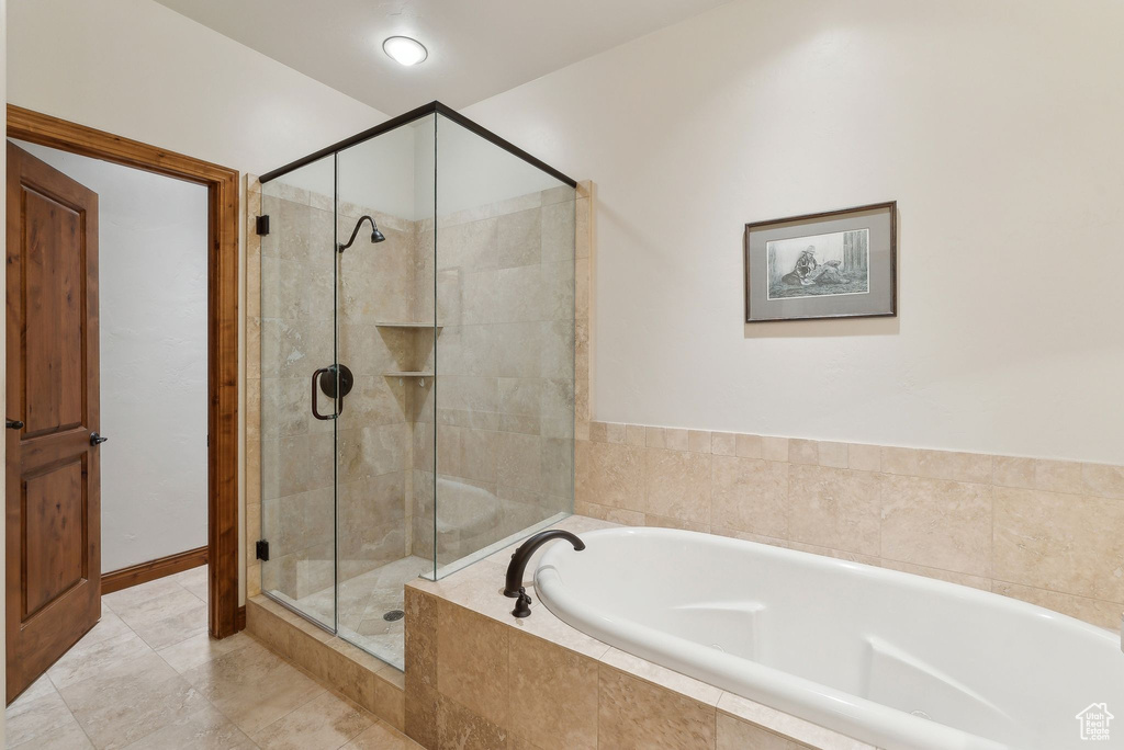 Full bathroom with a stall shower and a bath