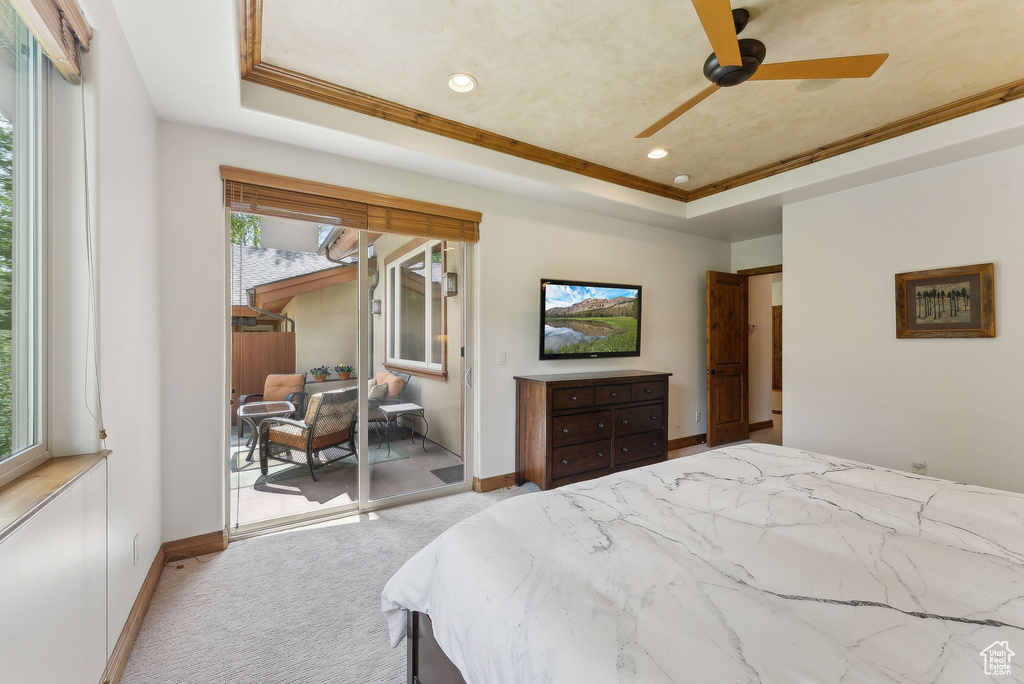Bedroom featuring a raised ceiling, access to exterior, carpet floors, baseboards, and recessed lighting