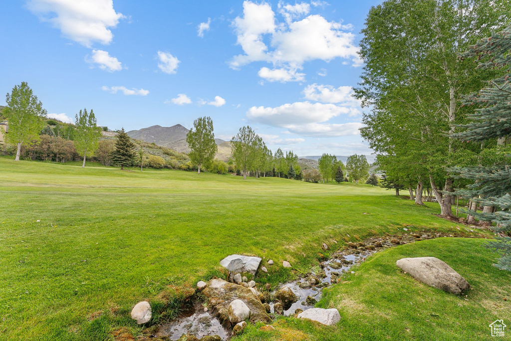 View of grassy yard featuring a mountain view and golf course view